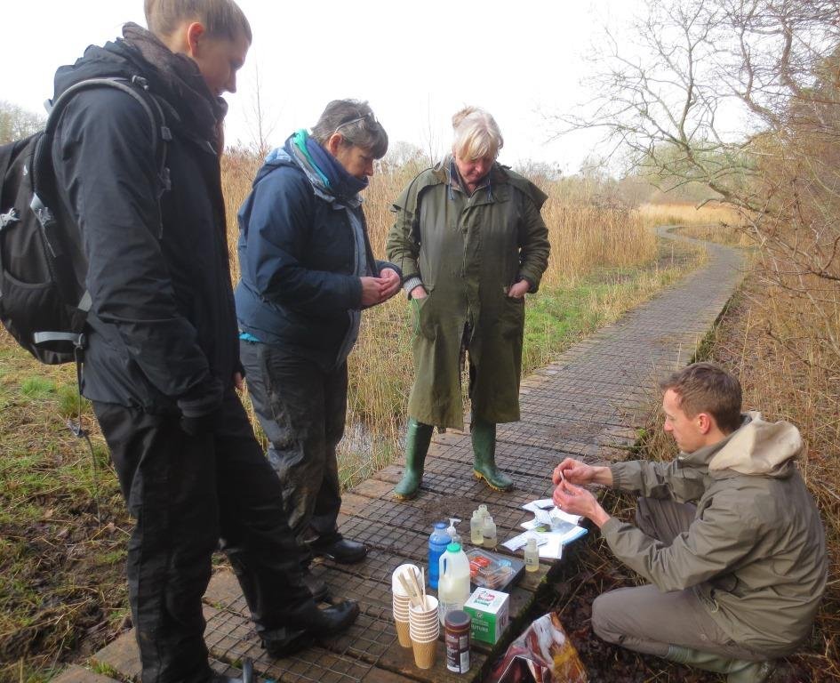 Project Officer Pete shows volunteers how to use testing kits to monitor water pollution levels on Cothill Fen Flagship Pond site, one of the finest freshwater sites in southern England. Photo credit: Judy Webb