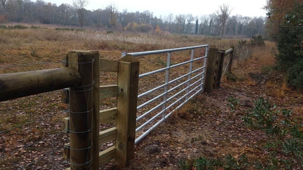 A new gate installed in a fence between Stow Bedon and Thompson Commons