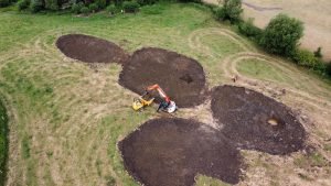 Aerial view of newly dug ponds with a digger